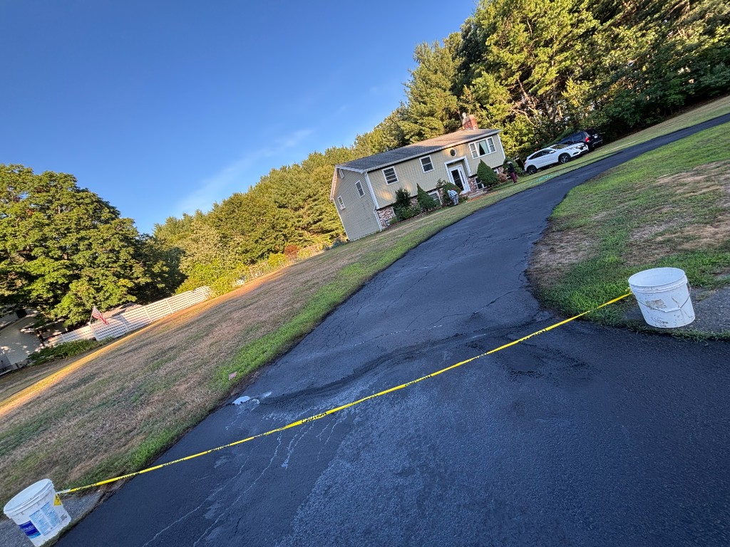Freshly sealcoated residential driveway with professional finish